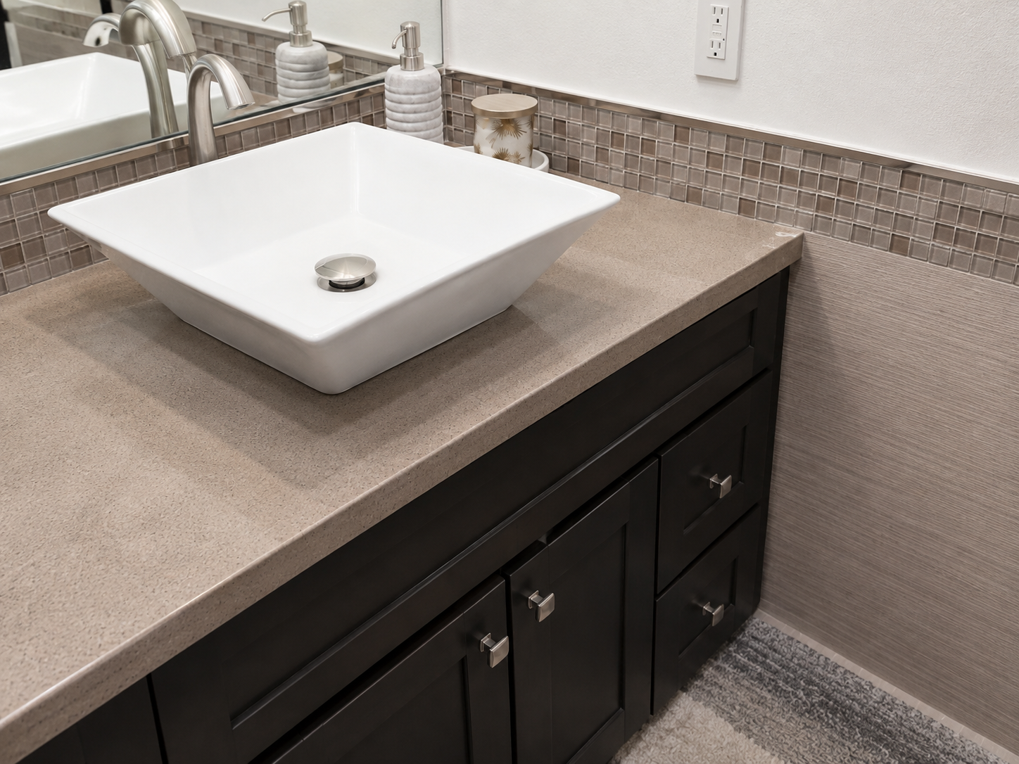 Inland Empire bathroom remodel with a walk-in tile shower, stone vanity and brass fixtures